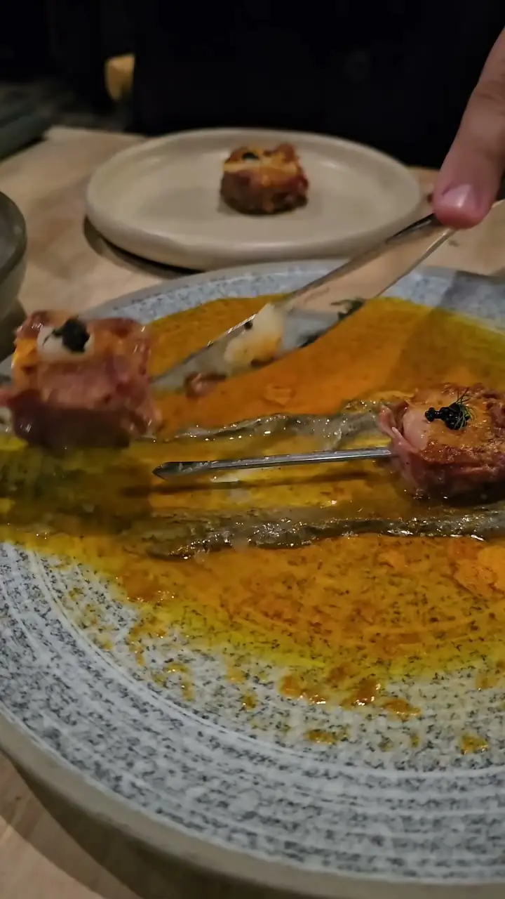 A date-night dinner reel at Rakkas - plated courses arriving at a candlelit table