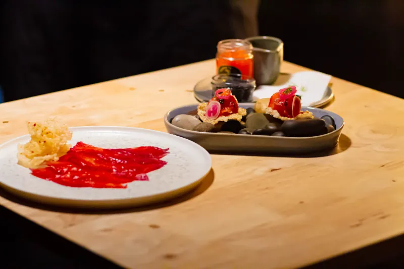 Beetroot carpaccio and rice-cracker canapés served on river stones