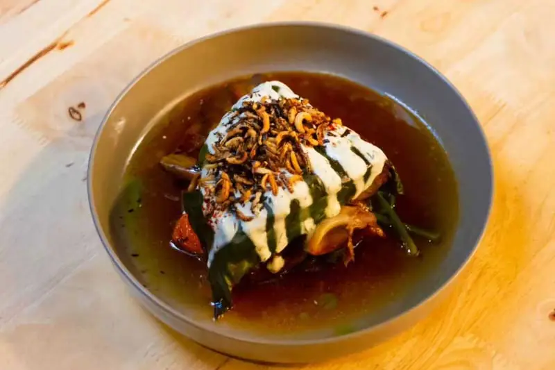 A wrapped Rakkas dish under yoghurt and crispy shallots, from the AGFG article