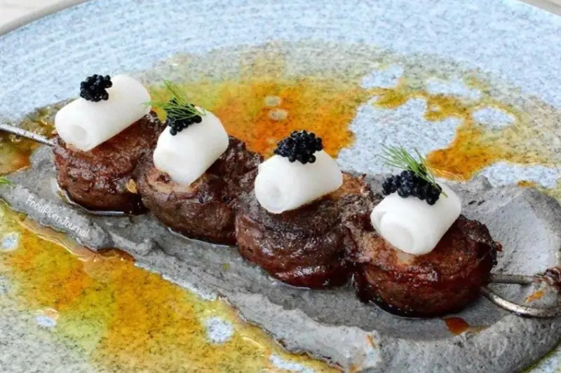 A Rakkas skewer topped with pickled daikon and caviar, from the AGFG article